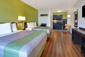 A hotel room with two beds, a kitchenette, a dining area, and a bathroom. - 2 Queen Beds | ADA/Tub/Micfridge (Destin)