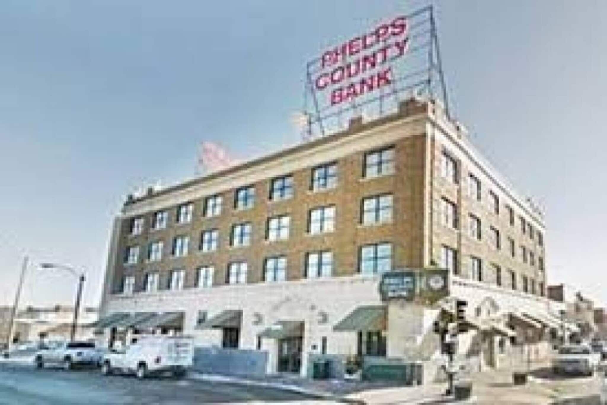 A multi-story building with a sign for Sheldon's County Bank on the facade.