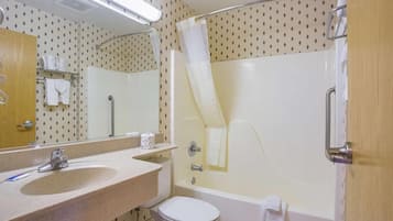 A bathroom with a sink, toilet, and bathtub.