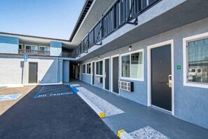 A building with a series of doors and windows, a ramp, and a no parking sign. - 1 King Bed | Non-Smoking, Micfridge (Ridgecrest CA)