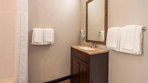A bathroom with a sink, mirror, and two towels on towel racks. - Spacious 2-Bed Queen|Fridge|Pool (Ridgecrest CA)