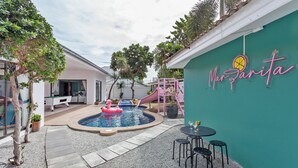 A pool area with a flamingo float, a slide, and a neon sign reading 'Mariana'. - 3-bedroom house in awesome Pattaya City with AC comfort (Pattaya City)