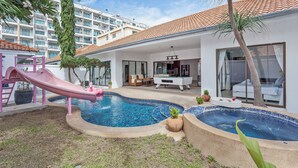 A pool area with a slide, a billiards table, and a lounge chair. - 3-bedroom house in awesome Pattaya City with AC comfort (Pattaya City)