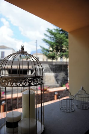 Una gabbia di metallo con candele su un balcone.