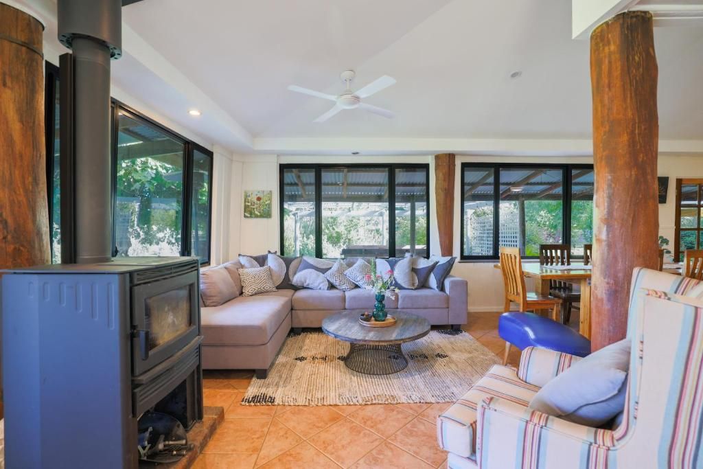 A living room with a sofa, a coffee table, and a fireplace.