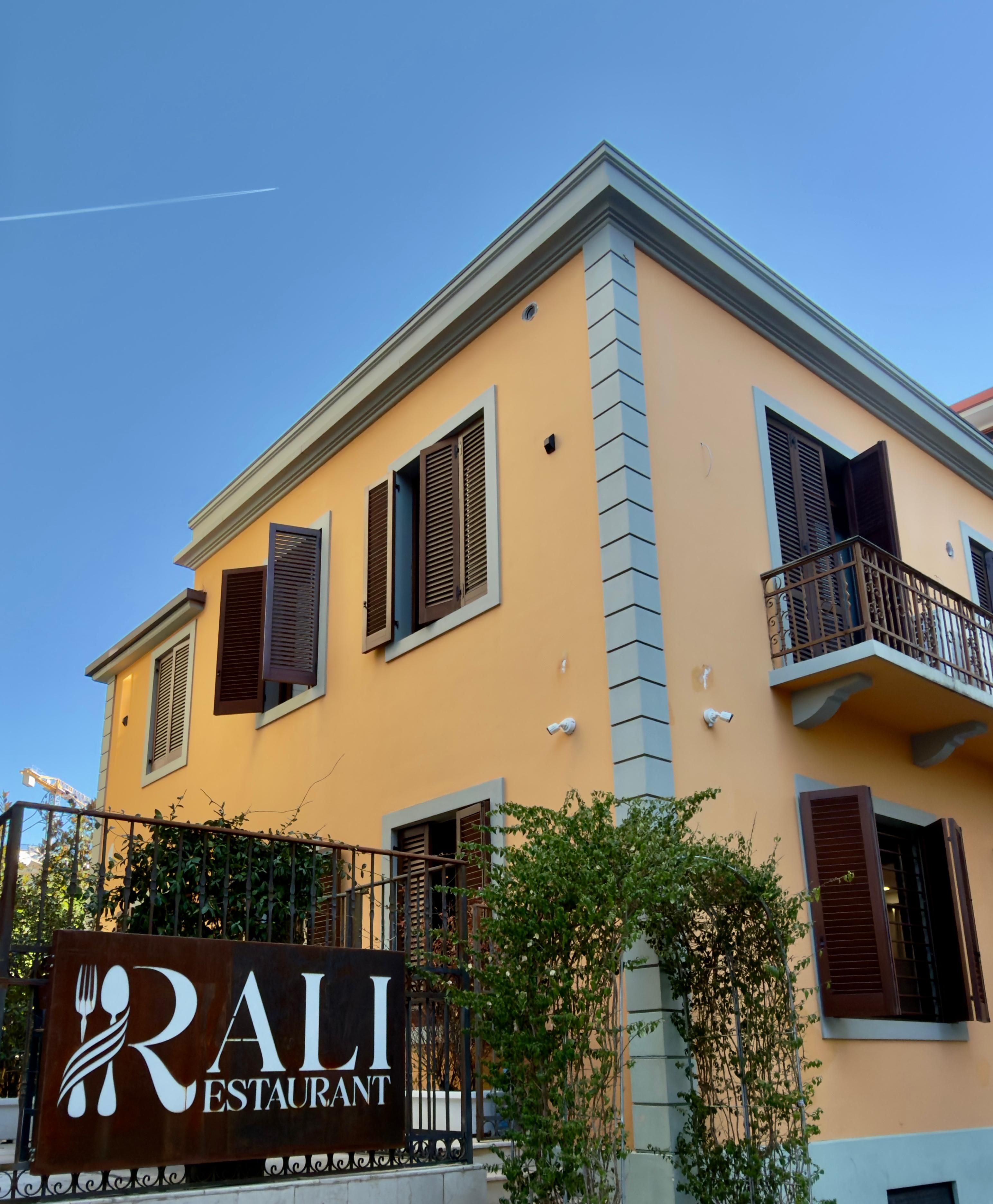 A two-story building with a sign for RALI RESTAURANT.