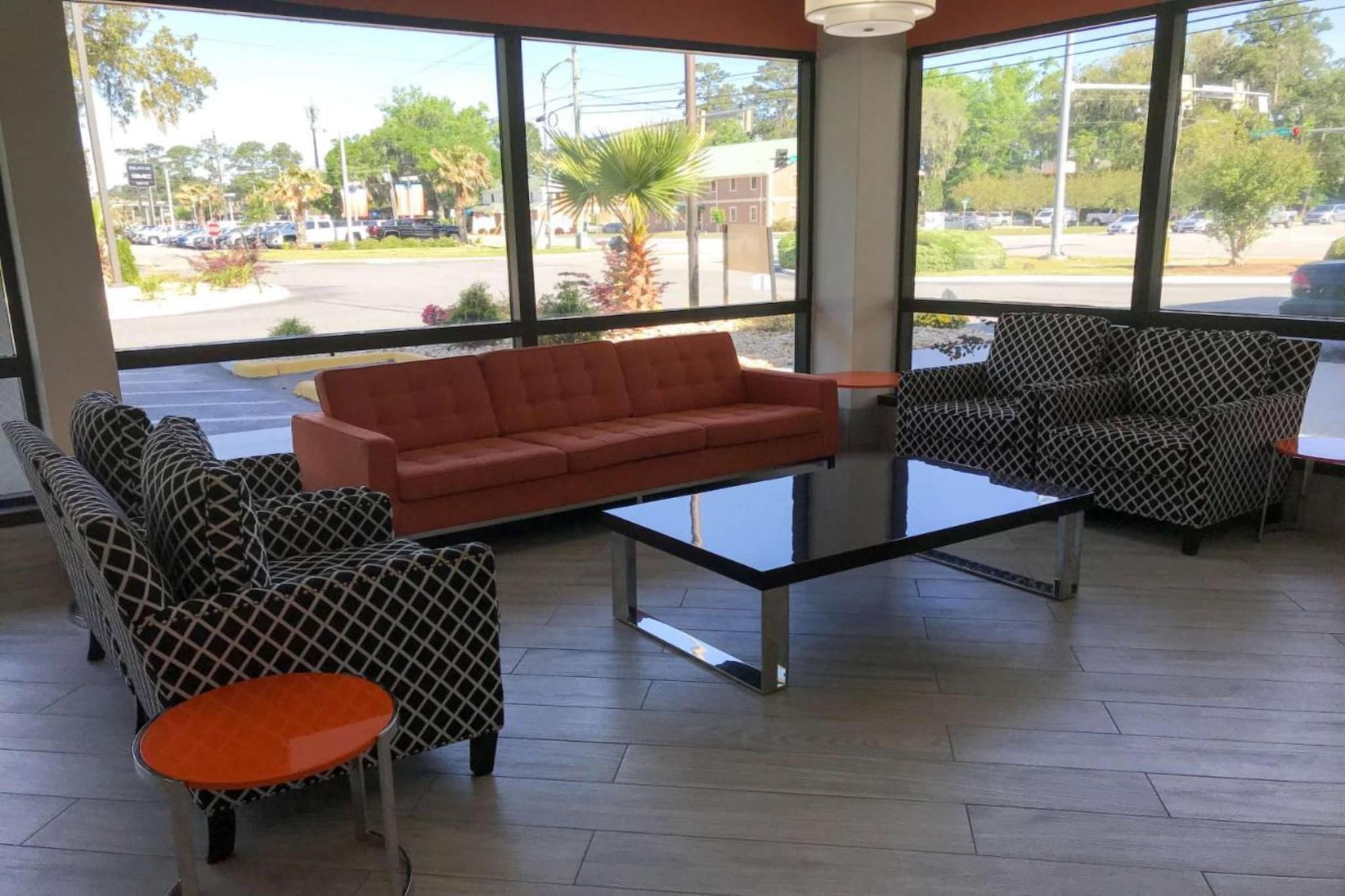 A seating area with a sofa, patterned chairs, and a small table.