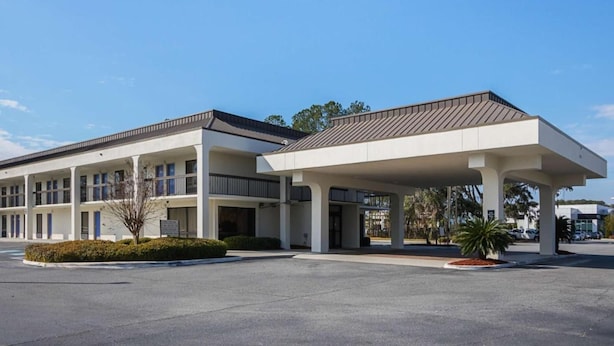 A two-story hotel with a covered parking area and a landscaped entrance. - 2 Queen Beds | Premium, Micfridge (Savannah GA)