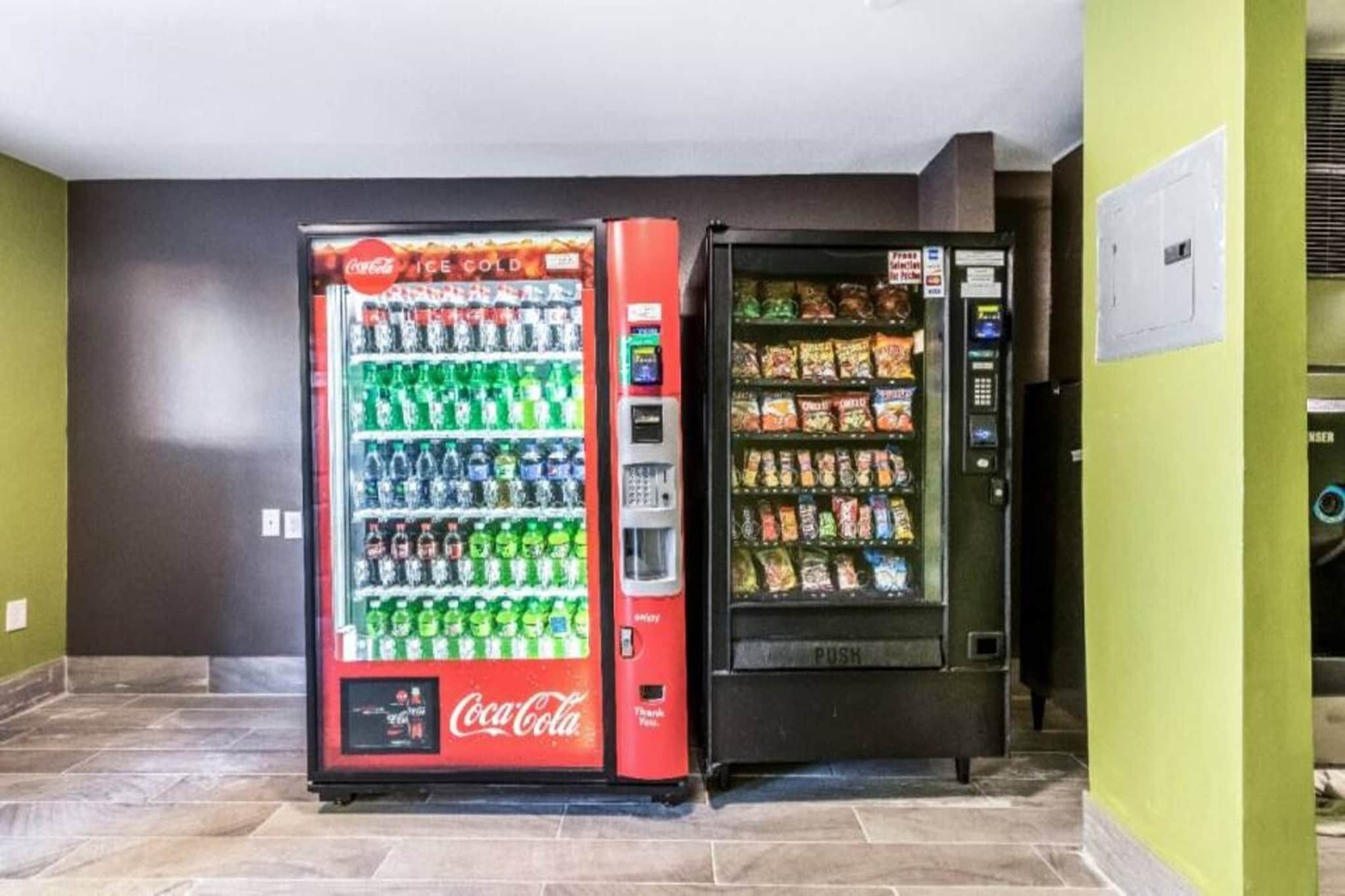 A vending machine with a Coca-Cola logo and a snack dispenser.