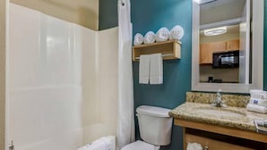 A bathroom with a shower, toilet, sink, and a mirror. - 2 Queen Beds|Mobil Access|Kitchen (Lenexa)