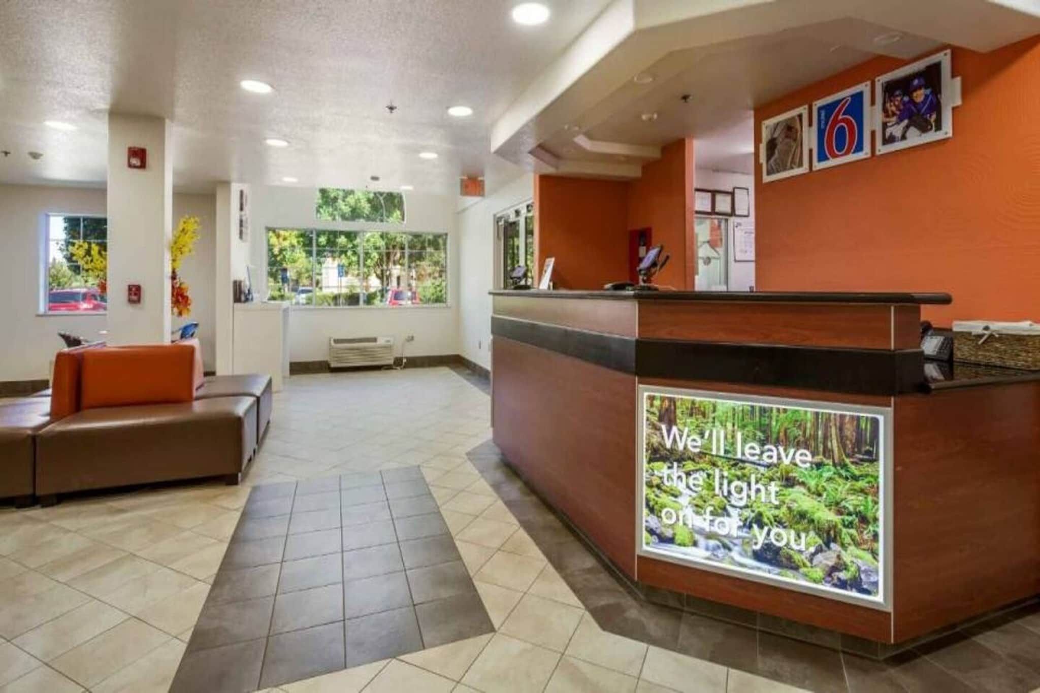 A reception area with a counter, seating, and a large window.