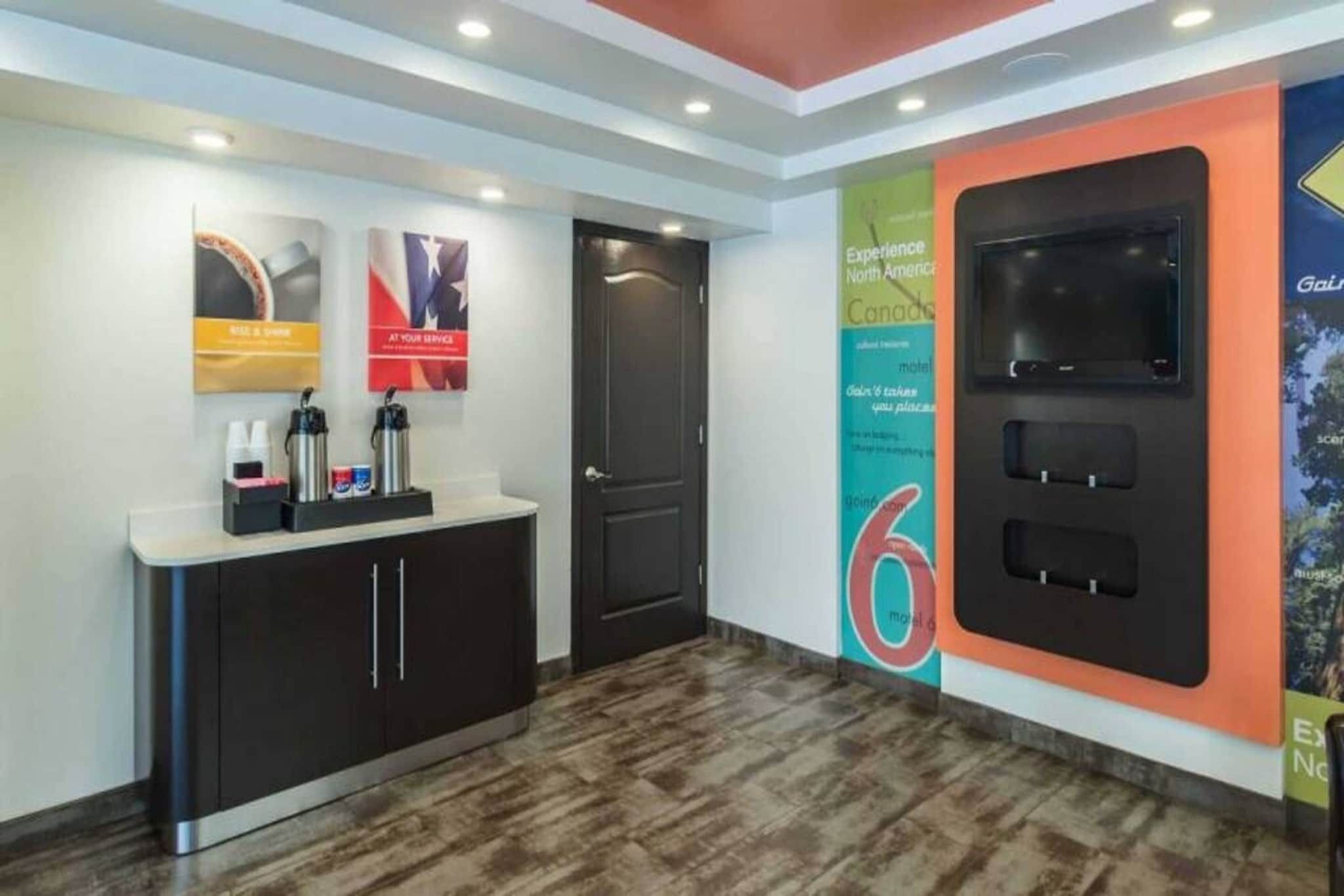 A reception area with a counter, a door, and a wall with a large number '6' sign.