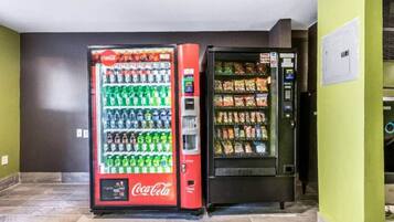 A vending machine with a Coca-Cola logo and a snack dispenser.