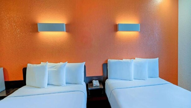 A hotel room with two beds, white linens, and a small bedside table with a phone. - 2 Queen Beds|Suite,Nsmk,Micfridge (Inglewood)