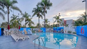 A swimming pool with lounge chairs and palm trees in the background. - 2 Queen Beds|Suite,Nsmk,Micfridge (Inglewood)