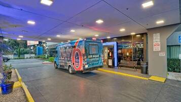A bus parked at a bus stop with a sign for LAX Airport.