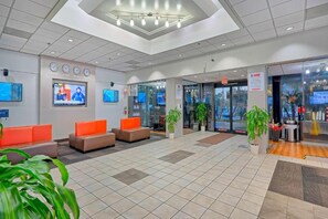 A lobby with seating areas, a reception desk, and a glass door entrance. - 1 King Bed|Nsmk,Hear Impair,Shower (Inglewood)