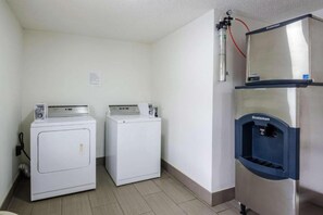 A laundry area with two front-loading washing machines and a stainless steel refrigerator with a water dispenser. - 1 KING BED | NON-SMOKING, KITCHEN (Troutville)
