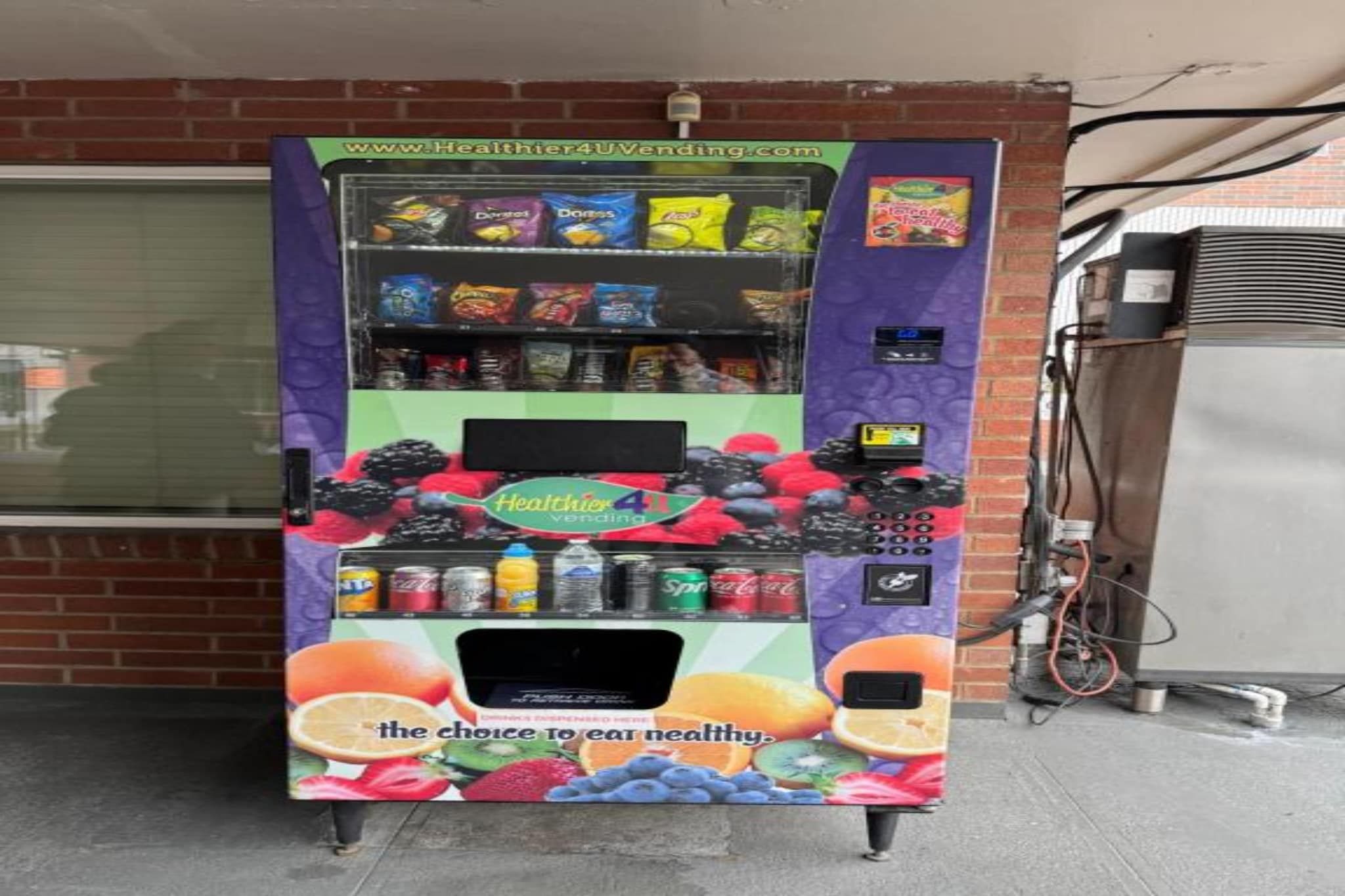 A vending machine with a variety of snacks and drinks, including a prominent display of fruit juices.