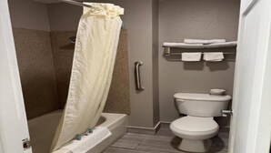 A bathroom with a shower, toilet, and a towel rack. - 2 Queen Beds | Smoking, Micfridge (Vancouver)
