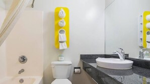 A modern bathroom with a bathtub, toilet, and sink. - Comfy Full Beds|Free Wifi &Parking (Jonesboro)
