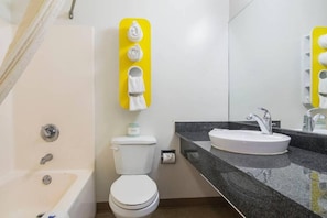 Ein modernes Badezimmer mit Badewanne, Toilette und Waschbecken.
