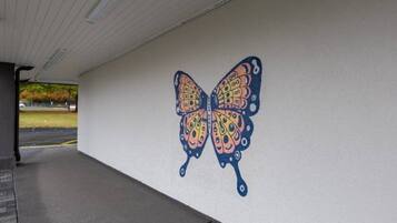 A wall with a butterfly mural.