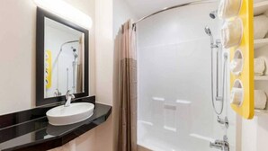 A modern bathroom with a round sink, a mirror, a shower with a glass door, and a towel rack. - 2 Full Beds|Smk,Mini Fridge (Fort Worth)