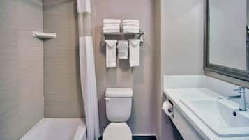 A bathroom with a bathtub, toilet, and sink.