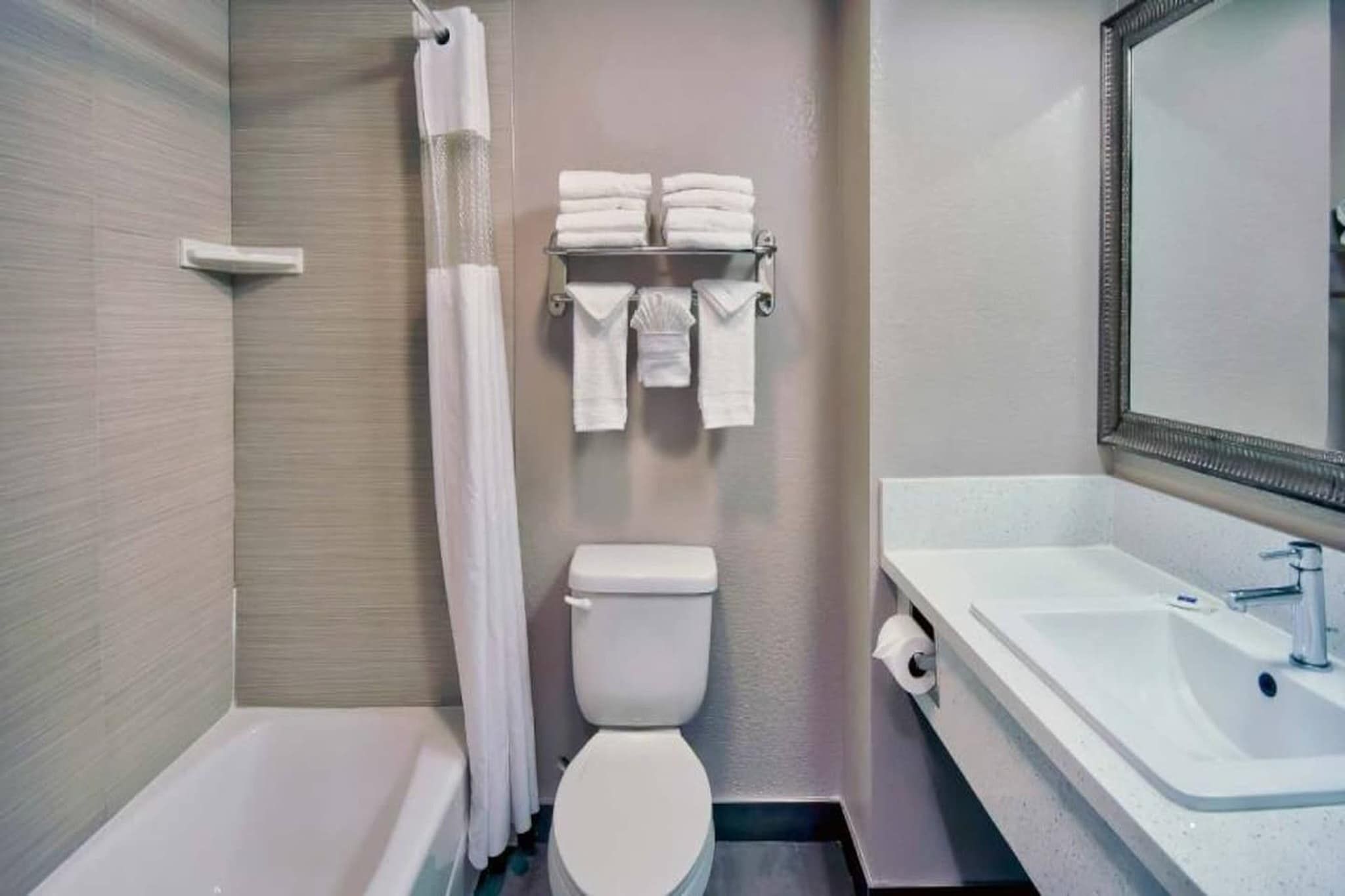 A bathroom with a bathtub, toilet, and sink.