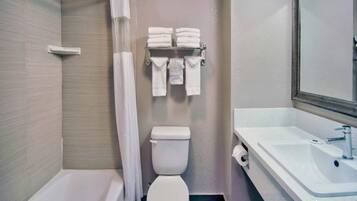 A bathroom with a bathtub, toilet, and sink.