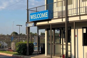 A building with a 'WELCOME' sign and a 'LOBBY' sign.