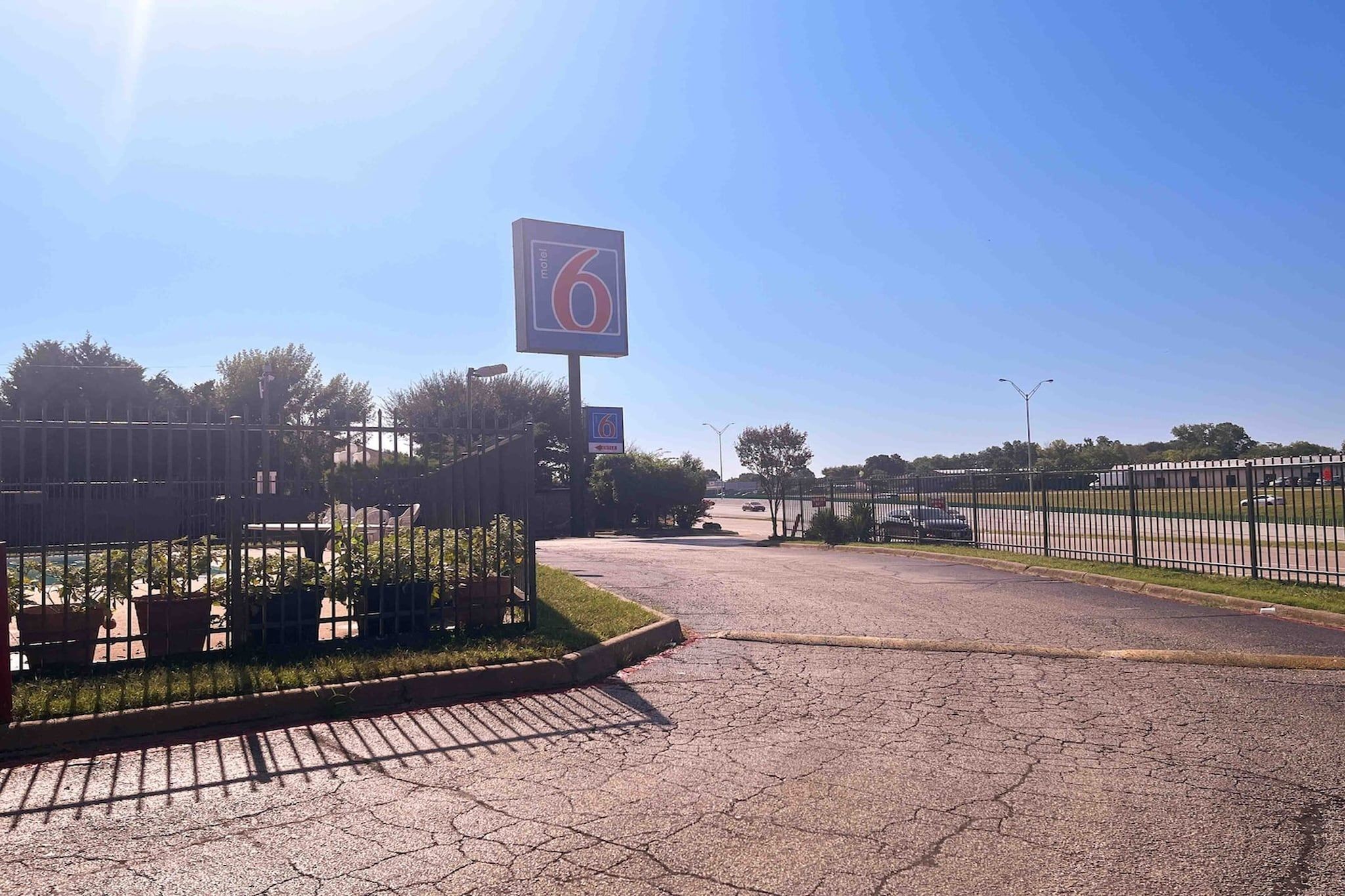 A parking lot with a large sign indicating a hotel entrance.