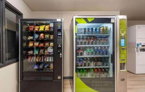 Two vending machines, one with snacks and the other with beverages.