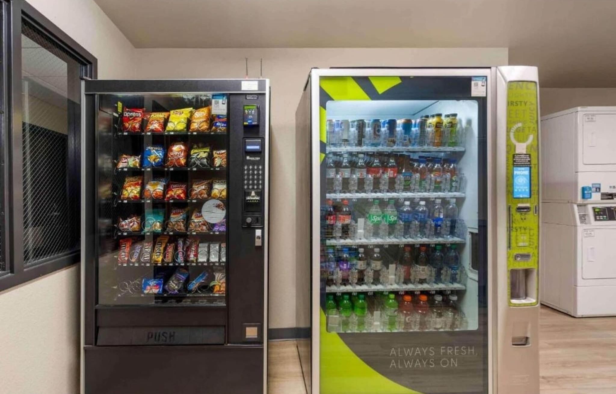 Two vending machines, one with snacks and the other with beverages.