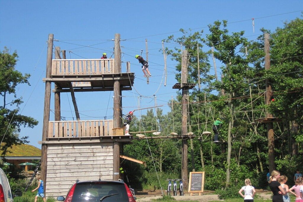 An outdoor adventure course with wooden structures and ropes.