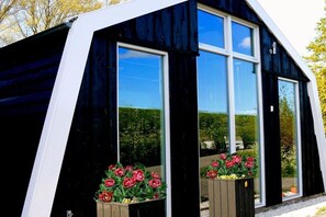 Moderni rakennus, jossa on suuret ikkunat ja musta julkisivu.