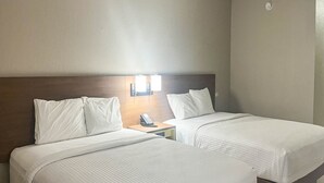 A hotel room with two beds, a nightstand with a phone, and wall-mounted lights. - 2 Queen Beds | Non-Smoking, Micfridge (Fremont (OH))