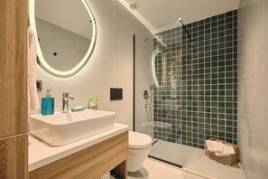 A modern bathroom with a glass-enclosed shower, a white sink, and a wooden vanity. - Kramnik, 2br, Cozy, Charming (Istanbul)
