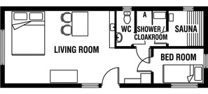 A floor plan with a living room, a bathroom with a shower and cloakroom, and a bed room.