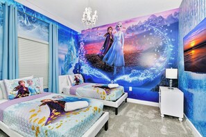 A bedroom with a mural of a character, two beds with matching bedding, a nightstand, and a chandelier. - 1128 Cozy Townhouse/Near Disney/Free Water Park (Davenport)
