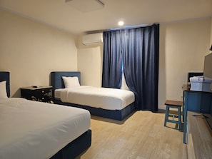 A hotel room with two beds, a desk, a chair, an air conditioning unit, and a curtain. - Prada Motel (Yangpyeong-gun)