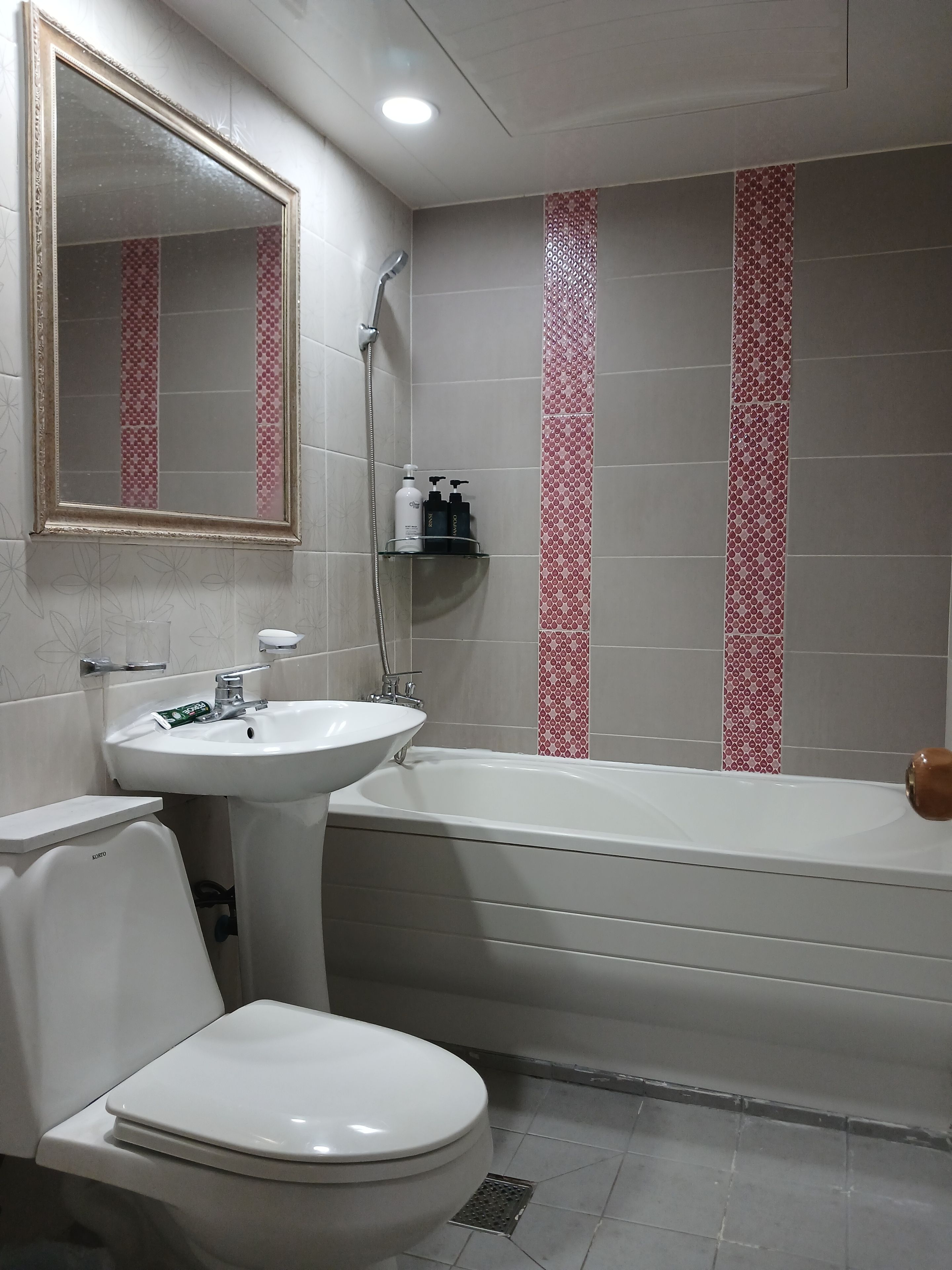 A bathroom with a toilet, sink, and bathtub.