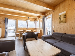 A wooden interior with a sofa, a table, and a chair. - Cabin in Annaberg With Swimming Pool (Annaberg-Lungoetz)