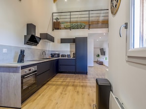A modern kitchen with a built-in oven, microwave, and coffee maker. - Souffle du Lac - Gérardmer, Vosges (Gérardmer)