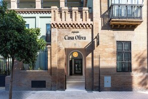 A building with a sign reading 'Casa Oliva' and a wrought iron gate. - Aspasios Casa Oliva (Sevilla)
