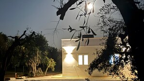 Um edifício com teto plano, uma janela visível e um caminho que o leva até ele.