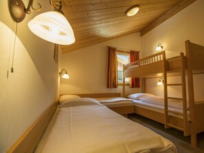 A room with two bunk beds, wooden walls, and ceiling lights. - Cabin in Annaberg With Swimming Pool (Annaberg-Lungoetz)
