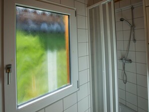 A bathroom with a shower, a frosted glass window, and a door handle. - Cabin in Annaberg With Swimming Pool (Annaberg-Lungoetz)