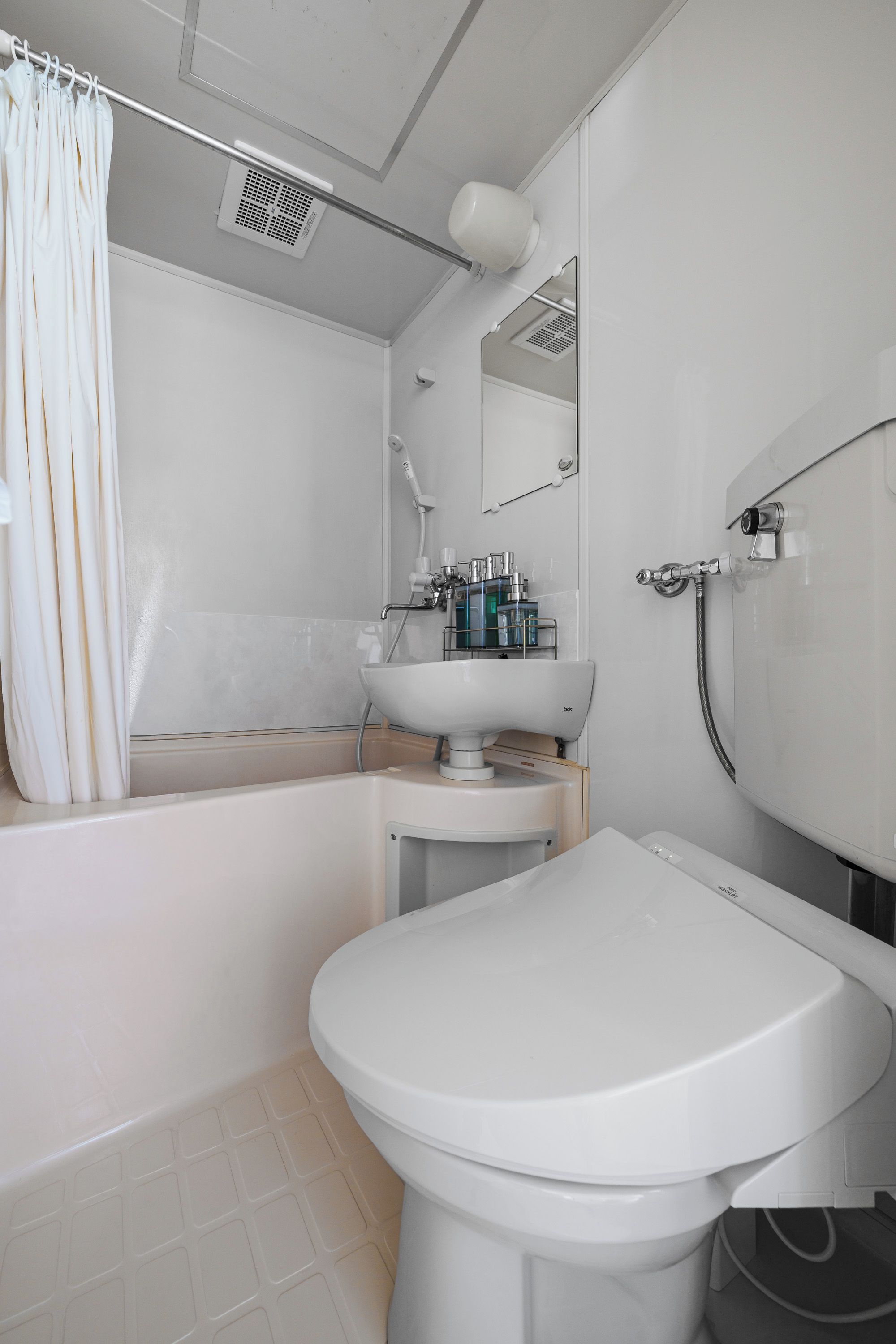 A modern bathroom with a bathtub, a toilet, and a sink.